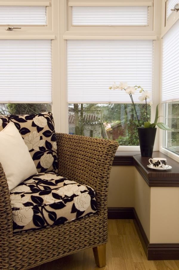 white blinds in conservatory with pleated seat